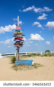 Signpost with destination mileage at Ocean View Beach in Norfolk, Virginia.