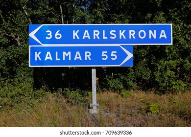 Signpost with distances and directions to the two Swedish cities Karlskrona and Kalmar. - Shutterstock ID 709639336