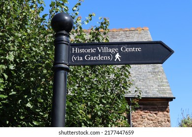 A Signpost In Dunster, Somerset Pointing To The Historic Village Centre