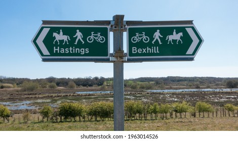 A signpost indicates direction to Bexhill and Hastings.Indicates suitable for bicycles, people and horses.Coombe Valley.Sussex.UK