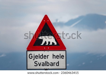 Signpost indicating the begin of the polar bear danger area in Longyearbyen, the world's northernmost settlement, Spitsbergen, Svalbard, Norway