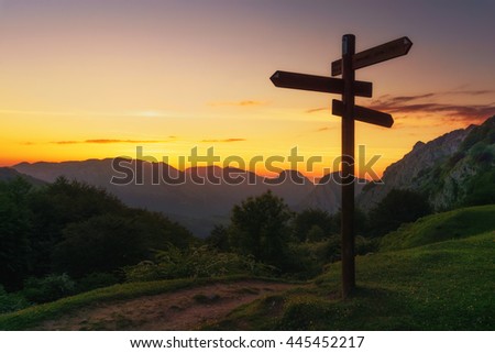 signpost in the mountain at the sunset