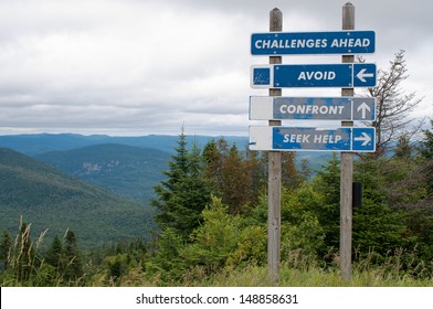 Signpost on top of the mountain warning challenges ahead and three options