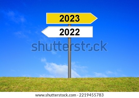 Signpost yellow and white showing year 2022 and year 2023