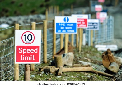 Signs Along The Path Of A Construction Site Including Speed Limit, PPE Must Be Worn Etc.