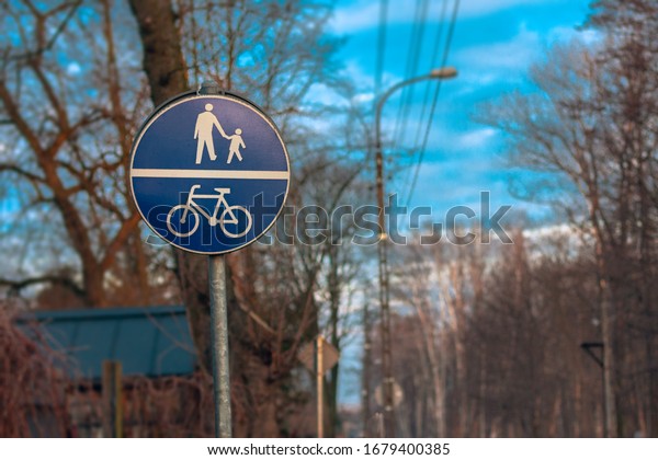 Signs ans signals for cyclists and\
pedestrians. Blue road signs on spring\
background.