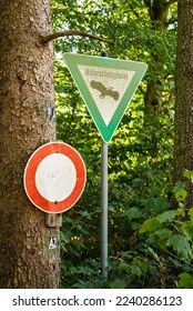 “Naturschutzgebiet” and “No entry!” signs in a forest, marking a nature reserve and conservation area, Germany - Shutterstock ID 2240286123