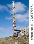 Signs with mileage to world destinations made into a totem pole, port stanley, falkland islands, south america