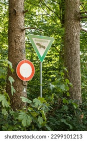 Signs "Naturschutzgebiet" and "No entry!" on the edge of a forest, marking a nature reserve and conservation area, Germany - Shutterstock ID 2299101213