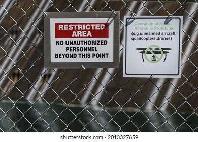 Signs on chain link fence reading 