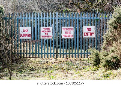 Signs on a security gate warning 