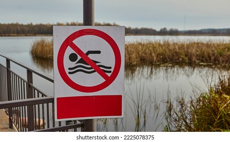 Signs posted at the end of the swimming season stating that swimming is prohibited. Signs are removed at the beginning of the swimming season. - Shutterstock ID 2225078375