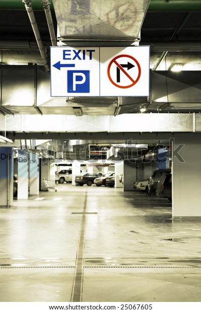 Signs in an\
underground parking with\
cars