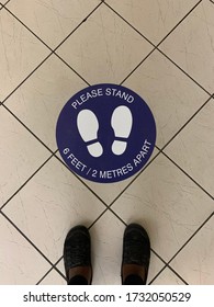 A Sign/sticker On The Floor Asking People To Stand Six Feet/two Metres Apart To Maintain Appropriate Social/physical Distancing And Prevent The Spread Of COVID/coronavirus