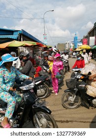 Sihanoukville, Cambodia. February 25, 2019: Lady Carrying A Child In Fashionable Pyjamas Busily Walking Outside The Street At Phsar Leu Market. 