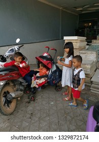 Sihanoukville, Cambodia. February 25,2019 : Children left at the motorcycle park playing by their own while parent marketing at Phsar Leu market. 