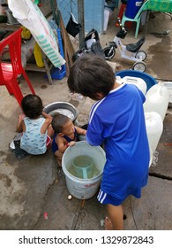 Sihanoukville, Cambodia. February 25,2019 : Children playing with water while parent serving customers at food stall at Phsar Leu market.