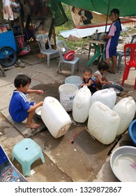 Sihanoukville, Cambodia. February 25,2019 : Children playing with water while parent serving customers at food stall at Phsar Leu market.