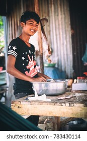 Sihanoukville, Cambodia - January 18, 2015: Cambodian boy cooks in slum village near Otres Beach in Sihanoukville, Cambodia