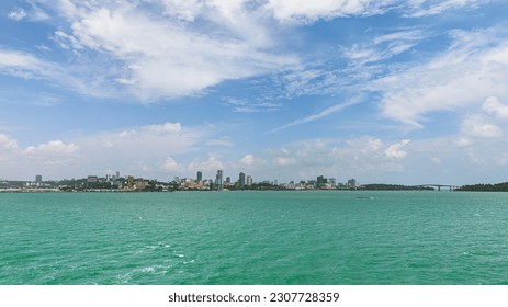 Sihanoukville City View Across the Gulf of Thailand. Turquoise Ocean Waters on a Sunny Clear Blue Sky Day. Oceanscape Horizon with Buildings in the Distance. Asia Shipping Port. Beautiful City.