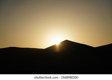 Sihouette of sunrise on desert mountain