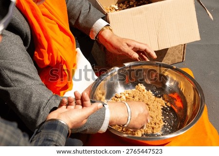 Sikh devotee hands serving Karah Parshad during Vaisakhi