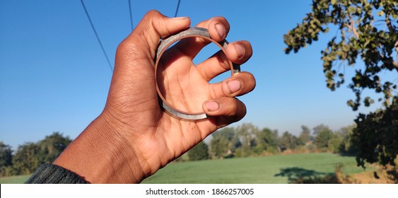 Sikh Khalsa Symbols Iron Bracelet Lohe Da Kara , Circular Kada Iron Bracelet On Nature Background , Photographs Taken In Different Angles.