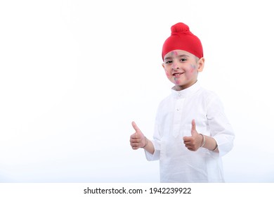 Sikh kid boy celebrating holi with full of happiness