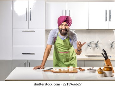 Sikh Man With Turban Working In A Kitchen Looking At The Camera And Smiling, Studio Shot