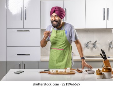 Sikh Man With Turban Working In A Kitchen Looking At The Camera And Smiling, Studio Shot