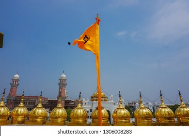 Sikh Orange Flag Flying On The Roof Of The Golden Temple