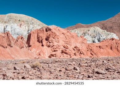 Erosion’s silent symphony revealed through layered mineral cliffs and desert stillness (Rainbow Valley, Chile: 05-sep-2013)