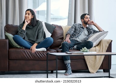 The Silent Treatment Isnt The Solution. Shot Of A Young Couple Sitting On The Sofa And Ignoring Each Other.