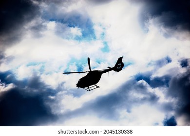 Silhouett Of A Patrol Helicopter Over City