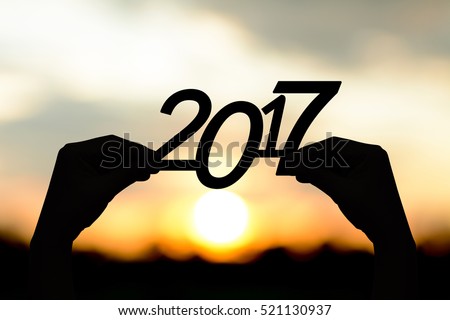 Silhouette  2017  in hand. Background sunrise