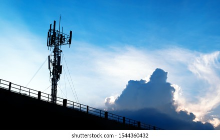 Silhouette of 5G smart mobile cellular network telephone radio network antenna base station on the telecommunication mast radiating signal.