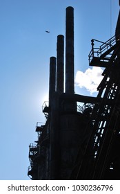 Silhouette Of Abandoned Steel Mill Against Blue Sky