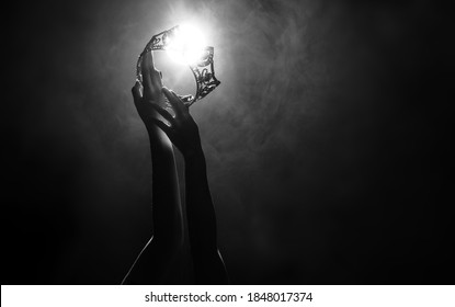 Silhouette abstract of two hands try to reach Diamond Crown as Miss Beauty Queen Pageant Contest as final competition, finale winner moment. Backlit smoke low exposure dark background copy space - Shutterstock ID 1848017374