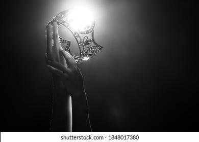 Silhouette abstract of two hands try to reach Diamond Crown as Miss Beauty Queen Pageant Contest as final competition, finale winner moment. Backlit smoke low exposure dark background copy space