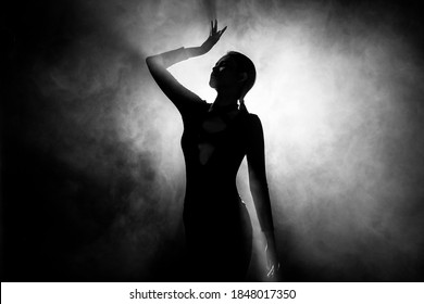 Silhouette Abstract Of Woman Body Presents As Miss Beauty Queen Pageant Contest And Win Diamond Crown. Backlit Smoke Low Exposure Dark Background Copy Space