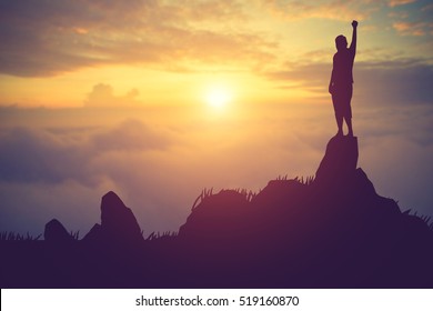 silhouette achievements successful arm up man is celebrating success with sunrise.Vintage color