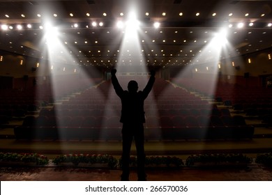 Silhouette Of Actors In The Spotlight