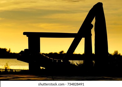 Silhouette Of Adirondack Chair During Evening Sunset Light