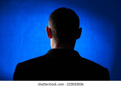 Silhouette Of An Adult Male In His Early Forties Wearing A Jacket And Shirt.