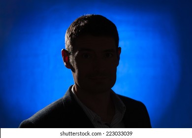 Silhouette Of An Adult Male In His Early Forties Wearing A Jacket And Shirt.