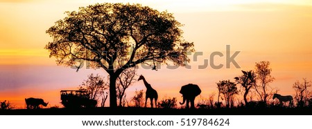 Silhouette of African safari scene with animals and vehicle