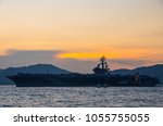 Silhouette of the aircraft carrier USS Ronald Reagan on a mission to Hong Kong during sunset