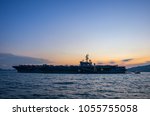 Silhouette of the aircraft carrier USS Ronald Reagan on a mission to Hong Kong during sunset