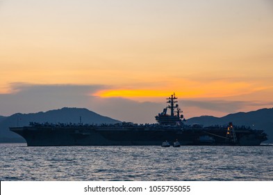 Silhouette Of The Aircraft Carrier USS Ronald Reagan On A Mission To Hong Kong During Sunset