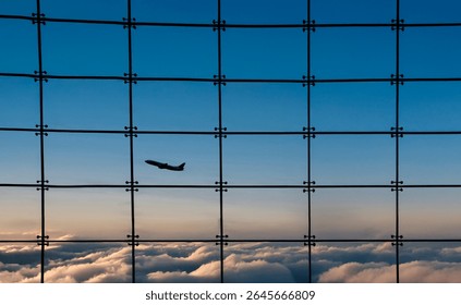 Silhouette of an airplane against a window with square grids and a sunset n the background and clouds below.. The effect looks like the shot was taken from an airplane  - Powered by Shutterstock - Get 15% off with code: PIKWIZARD15